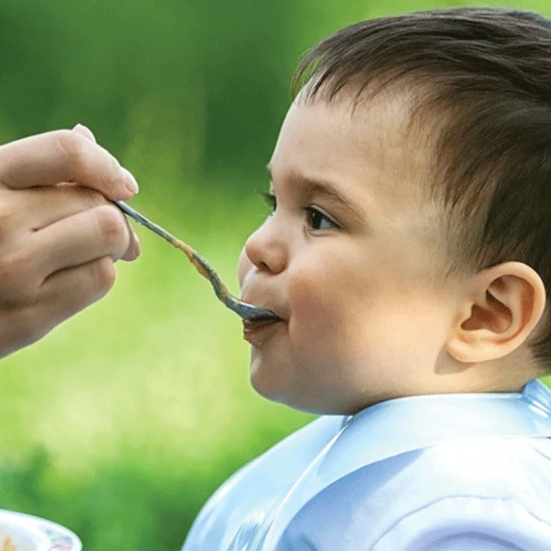 Banner baby in profile eating